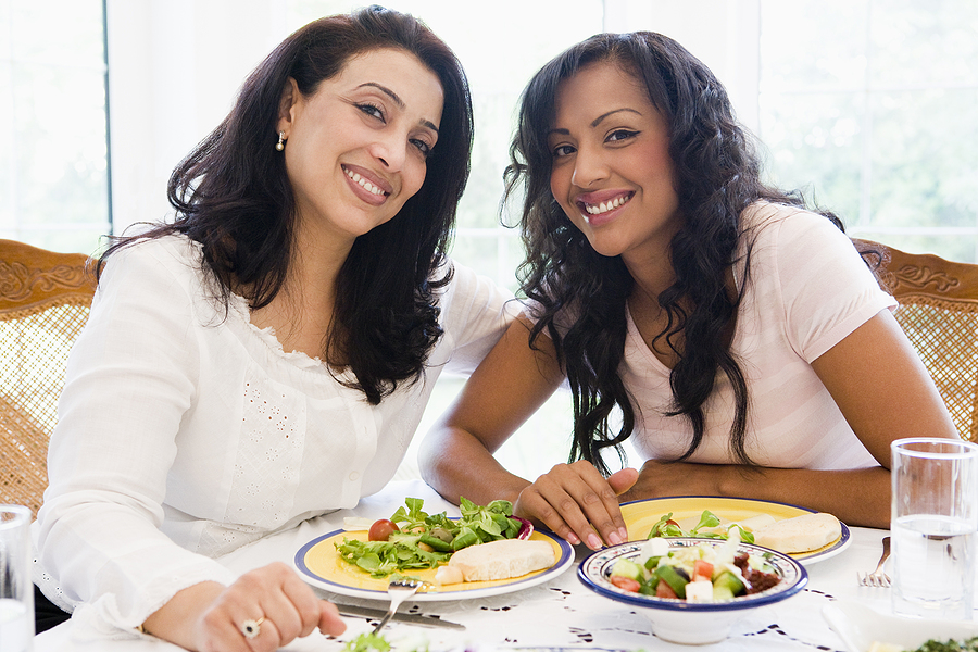 Middle Eastern Women Sit at a Table Eating Food