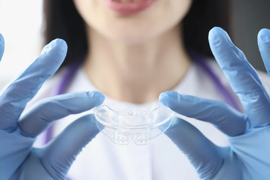 Dentist Doctor Holding Mouth Guard For Teeth Whitening Closeup